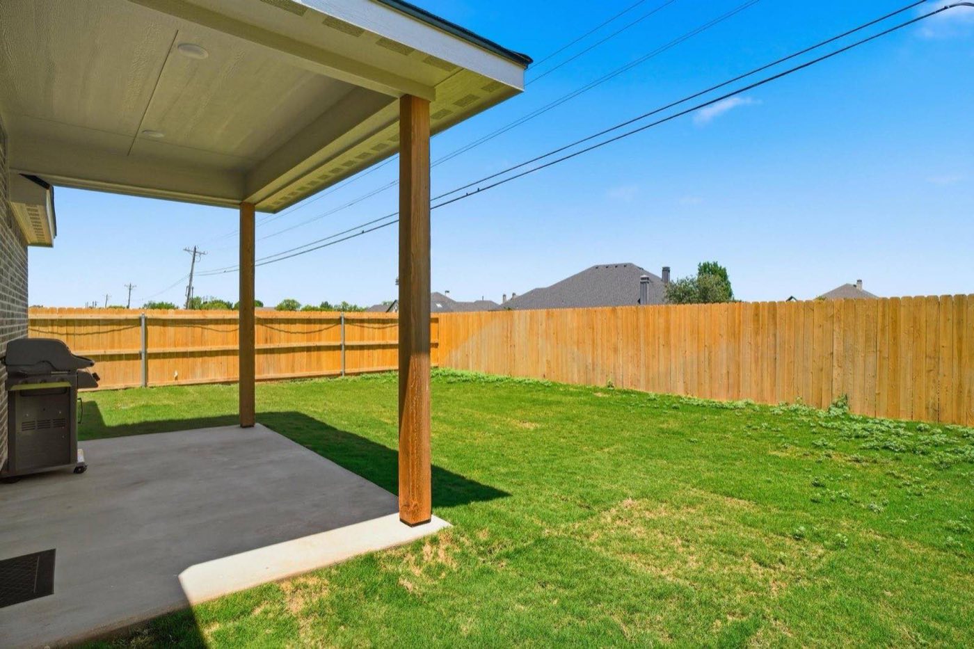 Covered back patio and fenced yard at Wylie East 1